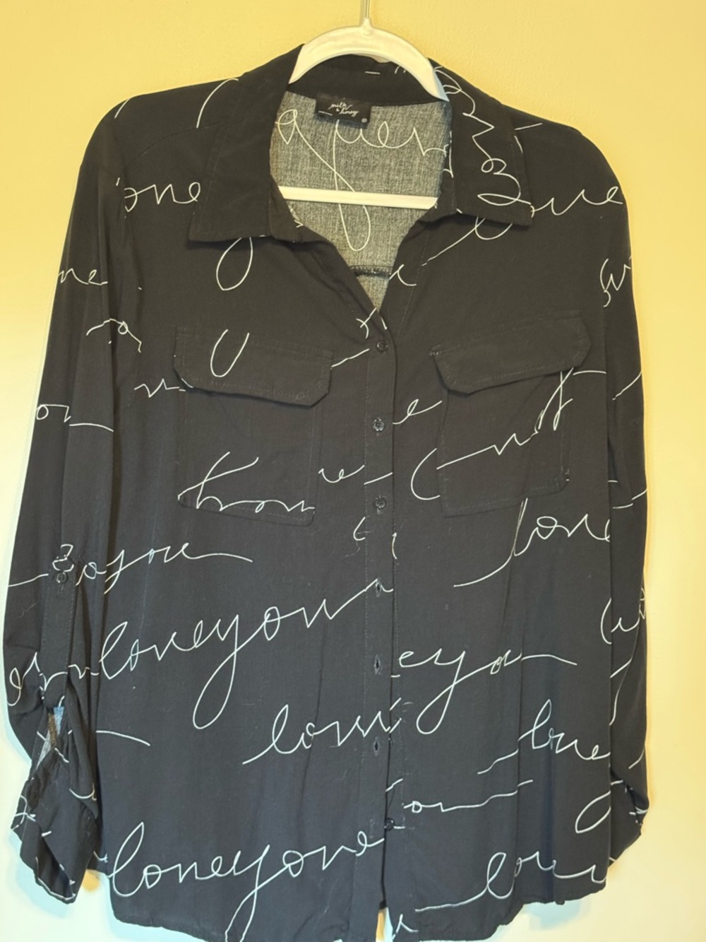 Black Button-Up Blouse with White Script. Front Patch Pockets.